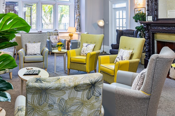 Communal area yellow chairs by the fire