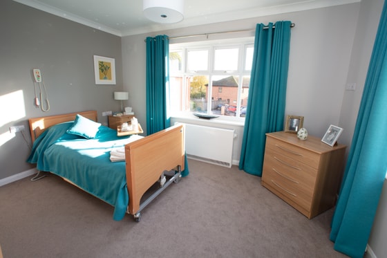 Teal curtains and bed