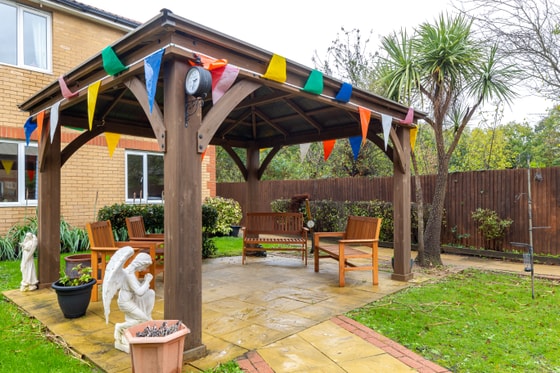 Statues and wooden outdoor bench