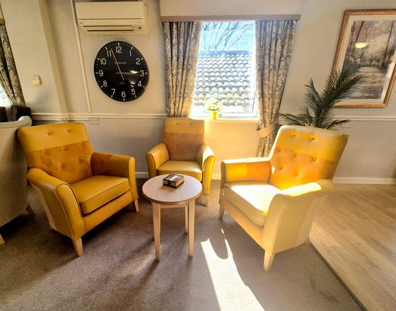 Orange chairs and large clock