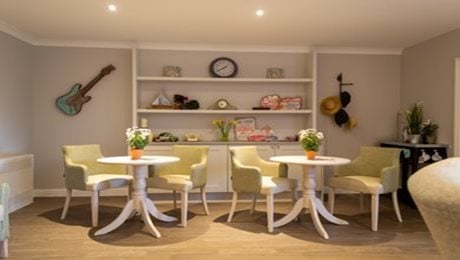 Quarry Hall Care Home - Dining area, tables, shelf, guitar, flowers