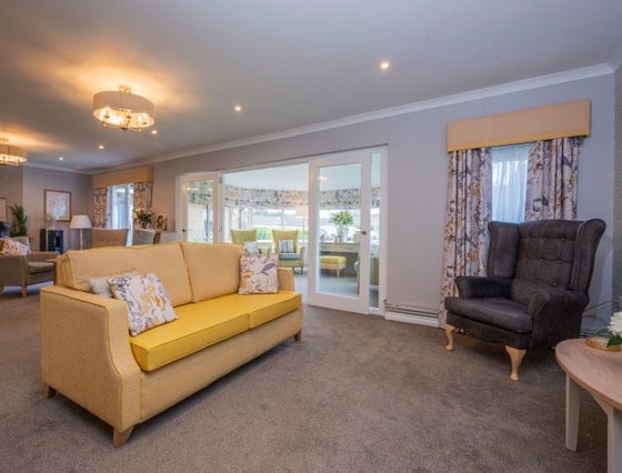 Hatton Lea Care Home - Communal living area, yellow sofa