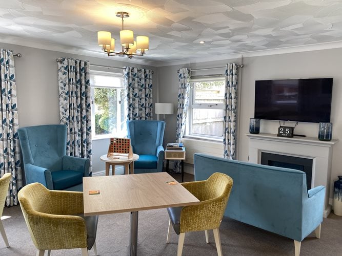 Plas Cwm Carw Care Home - Plas Cwm Carw living area with a tv and chairs