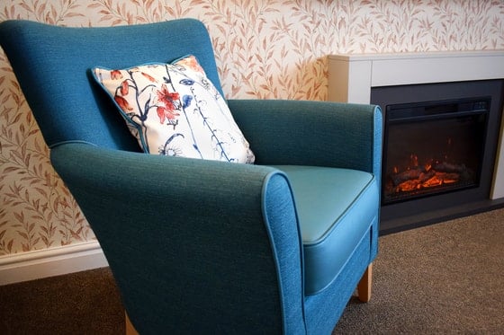 Pendleton Court Care Home - Blue chair and fireplace