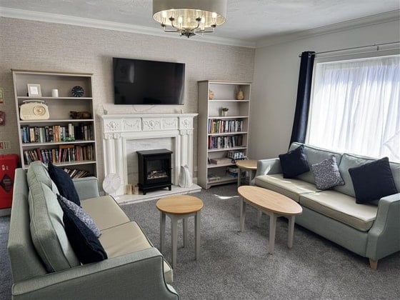 Highfield Care Home - 2 cream sofas and television
