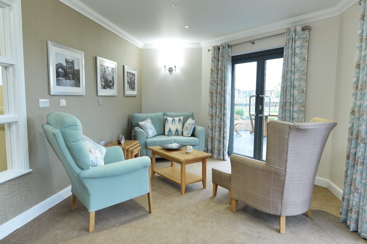 Ebor Court Care Home - Care home sitting area with blue and beige armchairs