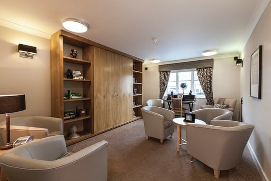 The Oakes Care Home - Wood cupboard and cream seating