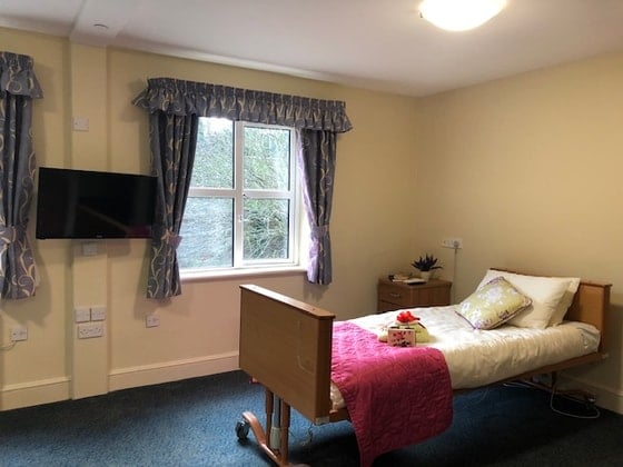 Elstree Court Care Home - Cream bed and television 