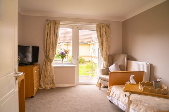 Colton Lodges Care Home - Orange curtains with single bed