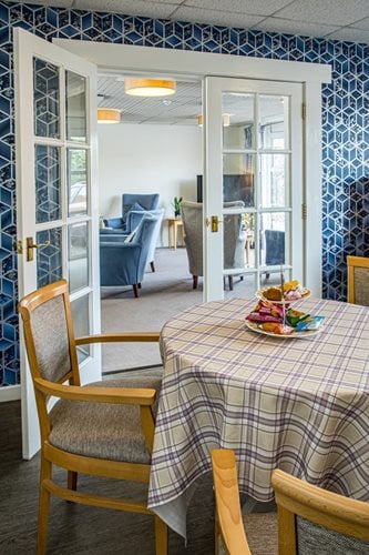 Springwater Lodge Care Home - Doorway from piano room to communal seating