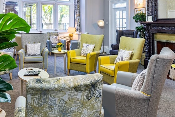 Bankwood Care Home - Communal area yellow chairs by the fire