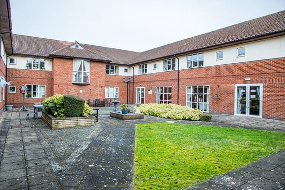 Springwater Lodge Care Home - Outdoor area with paths, grass and plants