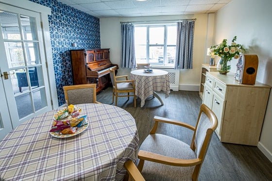 Springwater Lodge Care Home - Small piano room with dining tables