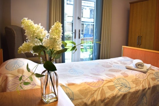 Pendleton Court Care Home - Single bed and flowers