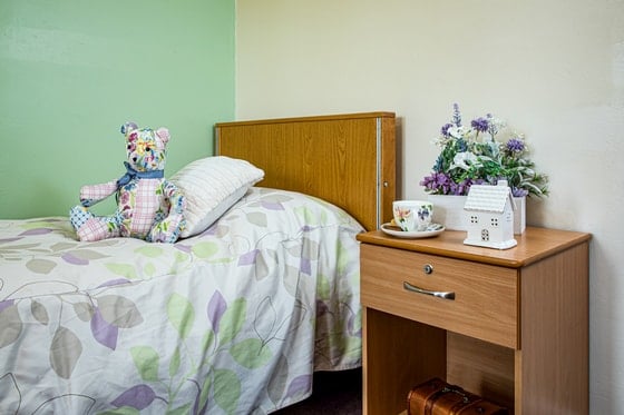 Springwater Lodge Care Home - Single bed, green bedroom