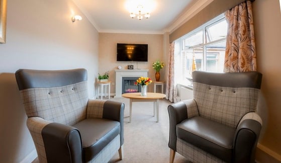 Greenfield Park Care Home - Grey and black seating by a fireplace