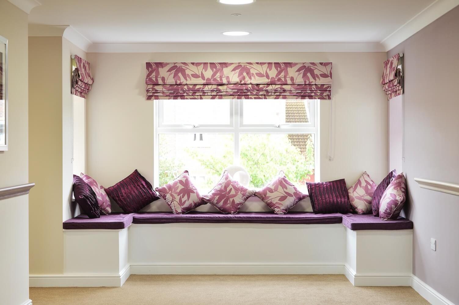 Ebor Court Care Home - Care home window seat with purple cushions and decorative pillows